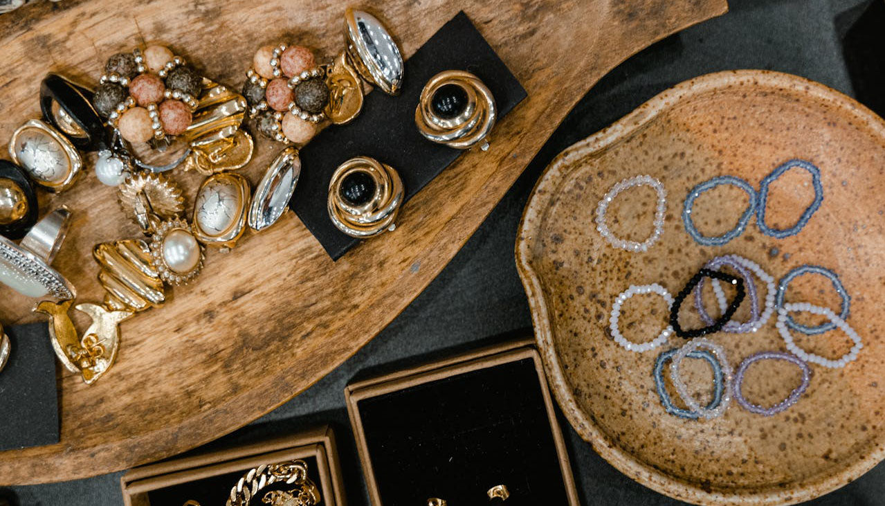 fashion jewelry pieces on wooden trays