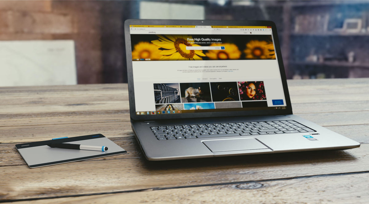 gray laptop on wooden table