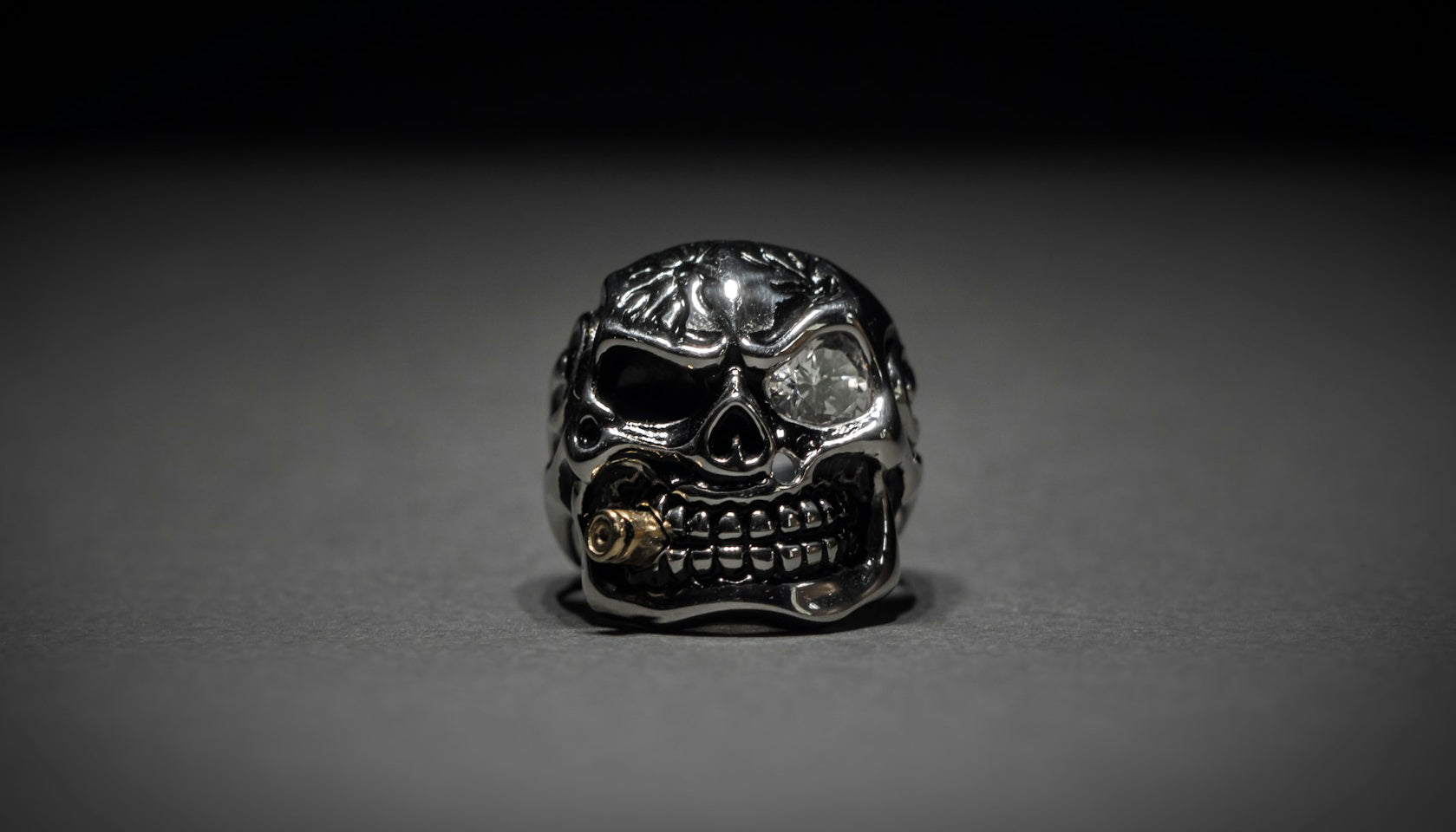 selective focus photo of a skull ring with vignette and dark vibes